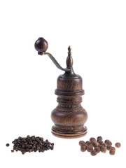 Mill for pepper with black peppercorns and allspice corns isolated