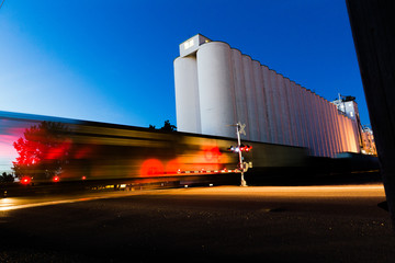 Train Moving Near Grain Silos © Shane Cotee