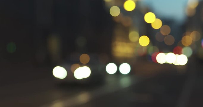 still blur background of night city with moving cars and walking people, 4k prores footage
