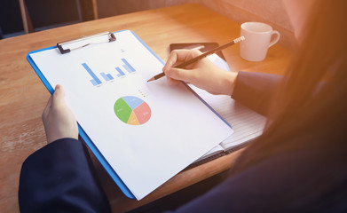 elegant Young business woman using busy touch screen tablet at the coffee shop wooden table, work break of business people, flare sun light