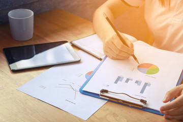 young woman student writes information from portable prepare for lectures in University campus, hipster businessman working on laptop computer writing business plan while sitting in cafe vintage color