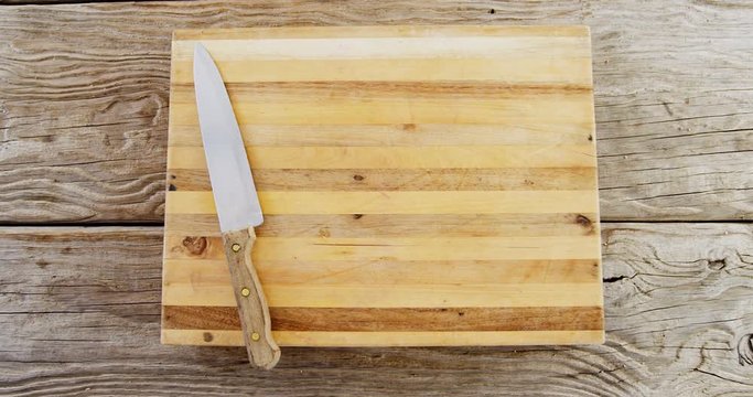Kitchen knife on wooden chopping board