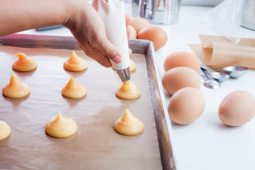 Piping dough before going to an oven.