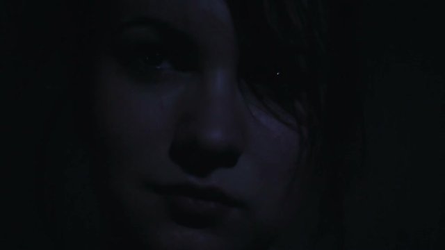 Face of a beautiful girl in the dark close-up