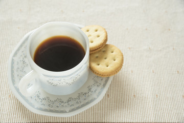 A cup of coffee and crackers