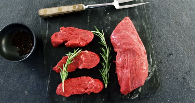 Raw meat and rosemary on the board