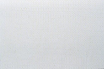 Sweater or scarf fabric texture large knitting. Knitted jersey background with a relief pattern. Wool hand- machine, handmade.