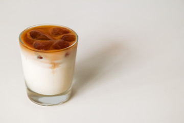 A glass of milk with coffee ice on the white background.