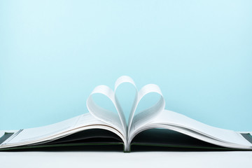Old open hardback book, page decorate into a flower shape for love in Valentine's. love with open book heart.