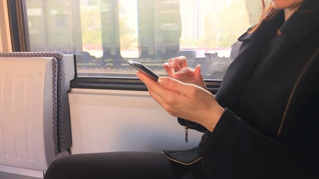 woman with mobile phone in the train
