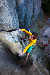 girl climber climbs the rock.