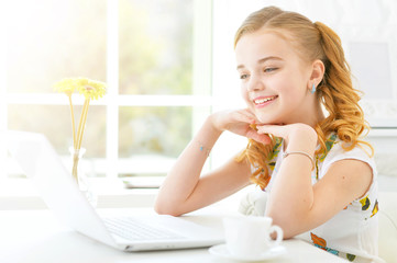 Little girl with modern laptop