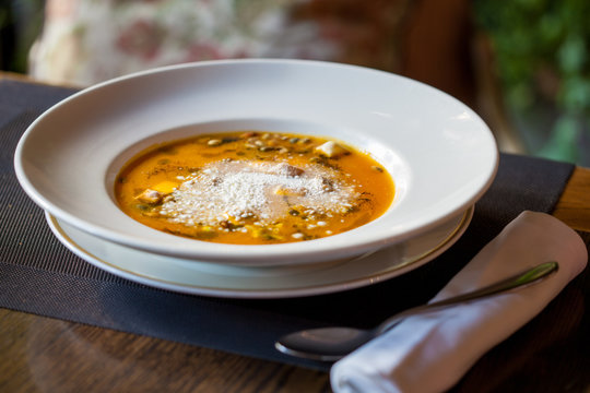 Pumpkin soup with parmesan in the restaurant. Restaurant food concept.