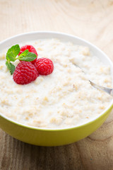 Obraz na płótnie Canvas Oatmeal porridge in bowl with berries raspberries and blackberries.