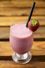 Strawberry smoothie on grass background.