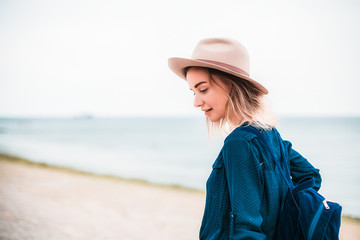 Summer portrait of young hipster woman in a brown hat having fun on the sea.young slim beautiful woman,bohemian outfit,indie style, summer vacation,sunny,having fun, positive mood,romantic