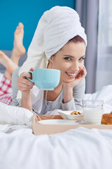 Girl after bath with a towel on her head. Breakfast in bed