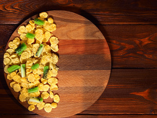 Still life with cornflakes on a wooden background