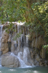 Fototapeta na wymiar Waterfall surrounded by tropical vegetation. Thailand