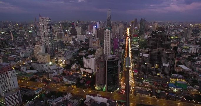 Aerial Hyperlapse at Dusk of Bangkok Skyline and traffic

