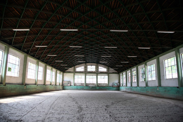 Abandoned riding hall without horses and horsemen