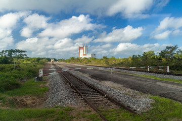 Fototapeta na wymiar Gate, transport tracks and The final assembly building for Ariane 5 space rocket at Centre Spatial Guyanais (Guiana Space Centre) in Kourou, French Guiana