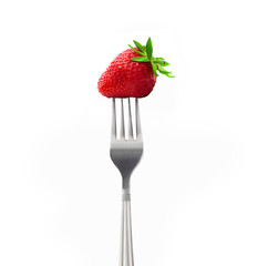 Strawberry on a fork isolated on white background