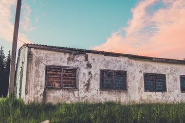 Fototapeta na wymiar Old, built of concrete and brick, an abandoned barn