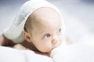 Beautiful baby girl on white blanket