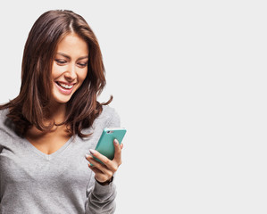 Fototapeta premium Young beautiful happy woman using smart phone