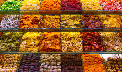 Multicolored spices, teas and nuts on the counter in the market