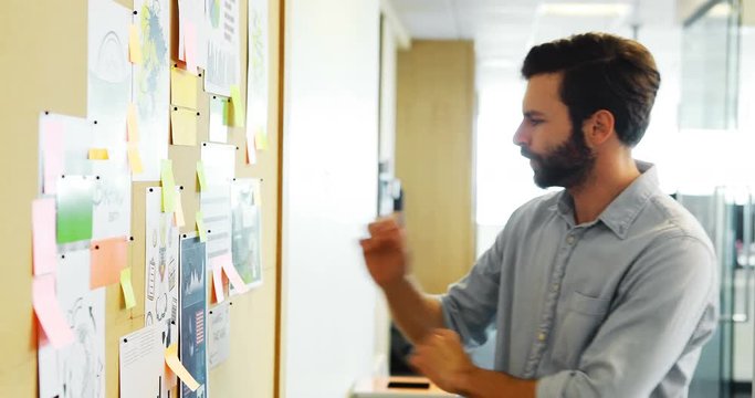 Male executive looking at bulletin board