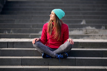 Young yoga woman on urban background in lotus, steps