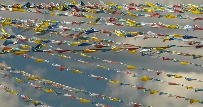 4k prayer flag in wind,clouds background.
