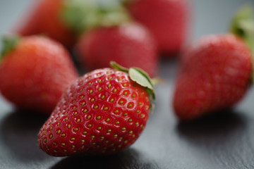 ripe organic strawberries on slate background, closeup