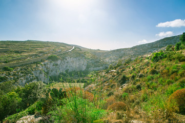 Fototapeta premium Sunset in beautiful valley to Mgarr ix-Xini in Gozo Island in Malta.