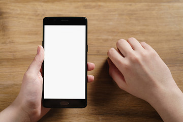 female teen hand holding smartphone with blank white screen, shallow focus