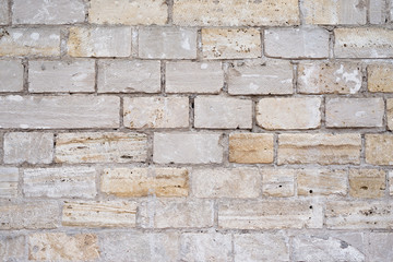 Obraz premium Part of a uneven stone wall with cement