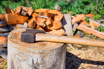 Great old hatchet against the pile of firewood.