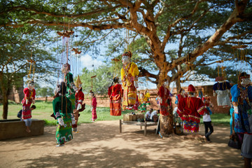 Traditional Burmese puppets hanging on display outside the Dhammayangyi Temple, Bagan Myanmar...