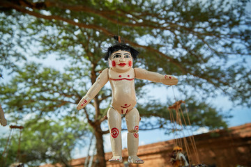 Traditional Burmese puppets hanging on display outside the Dhammayangyi Temple, Bagan Myanmar...
