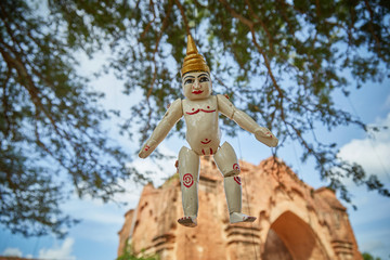 Traditional Burmese puppets hanging on display outside the Dhammayangyi Temple, Bagan Myanmar...