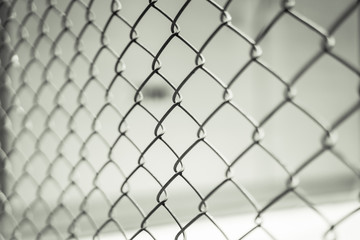 Steel mesh fence in black and white.