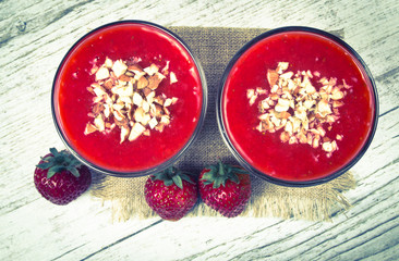Strawberry smoothie with fresh fruit .