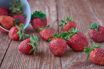 Delicious red sweet fresh strawberry on a wooden background.