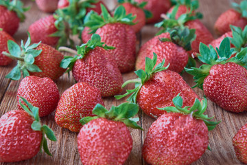 Delicious red sweet fresh strawberry on a wooden background.
