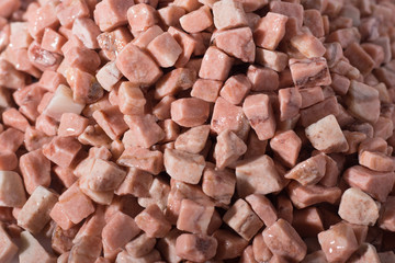 beautiful natural pink stone scattered on a white background