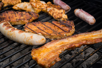 Close up of grilled sausages and steaks