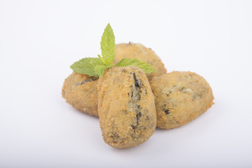 a handful of homemade croquettes of spinach isolated on white
