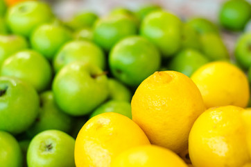 beautiful color combination, lemon and green apple background display at market stall.